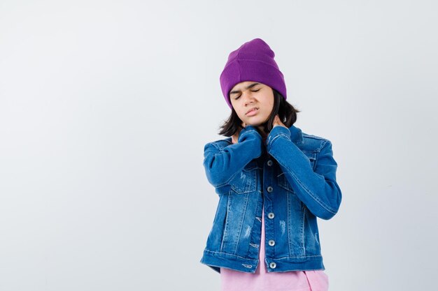 Teen woman in checkered shirt and beanie gesticulating isolated