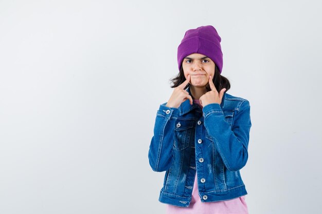 Teen woman in checkered shirt and beanie gesticulating isolated