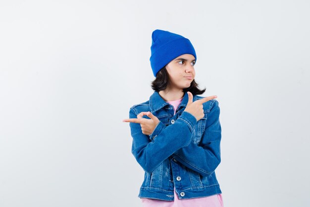 Teen woman pointing opposite directions with index fingers looking cute