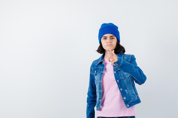 Teen woman pointing with index finger looking confident