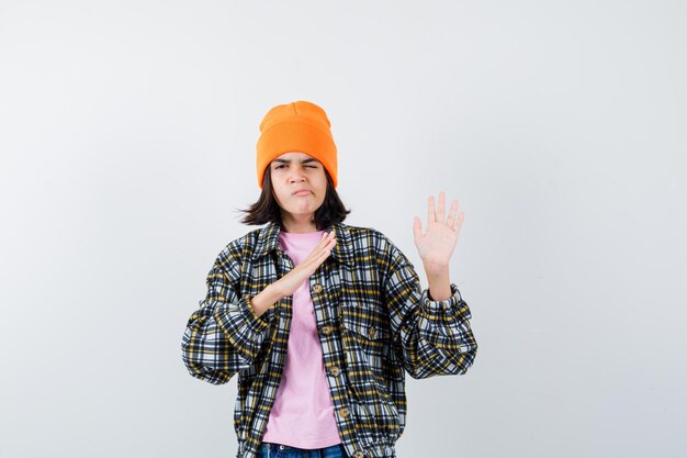 Teen woman raising hands to defend herself