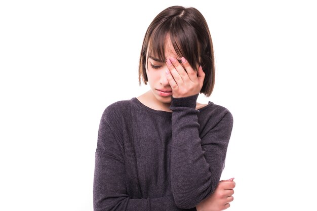 Teen woman with headache holding her hand to the head, isolated