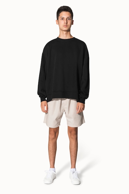 Free photo teenage boy in black sweater winter apparel portrait