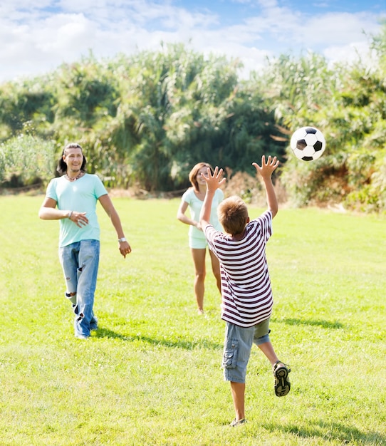 teenage boy and happy parents playing in soccer