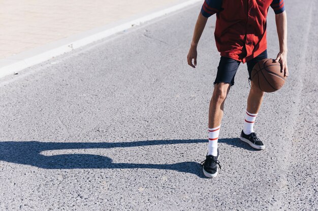 Teenage boy playing basketball