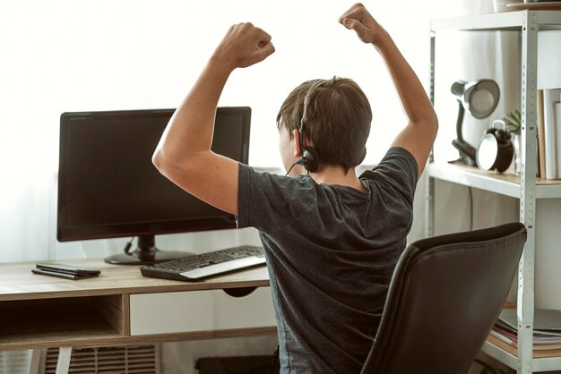 teenage boy winning a video game