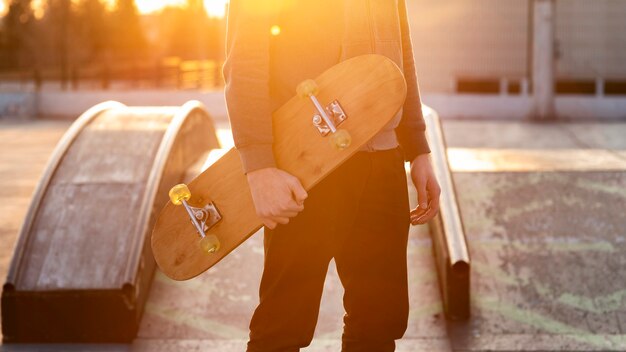 Teenage boy with skateboard close up