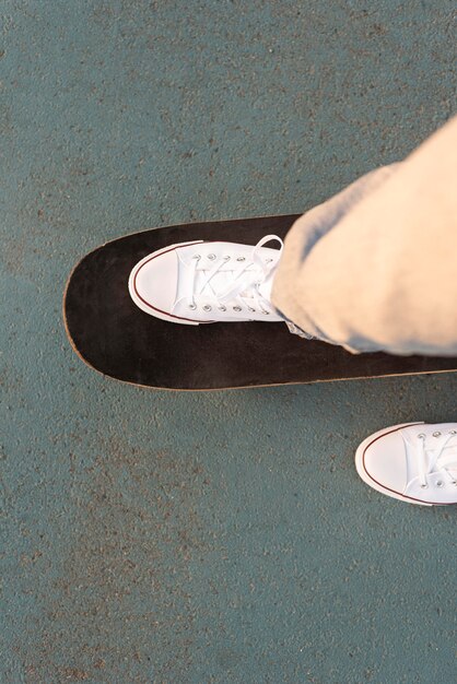 Teenage boy with skateboard close up