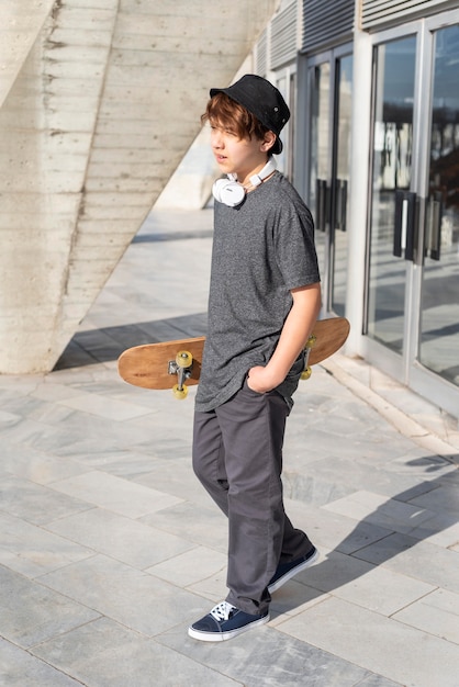 Free photo teenage boy with skateboard