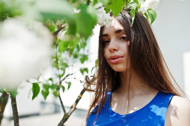 Teenage girl in blue dress posed outdoor at sunny day