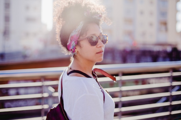 Teenage girl in headband standing outside