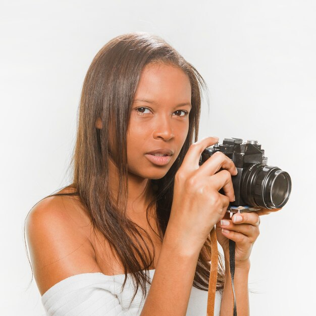 Teenage girl holding dslr camera