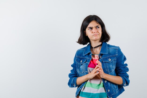 The teenage girl is thinking on white background