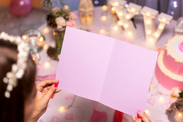 Teenage girl looking at empty birthday card