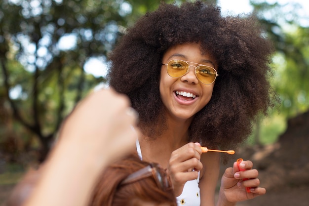 Free photo teenage girl playing with soap bubbles