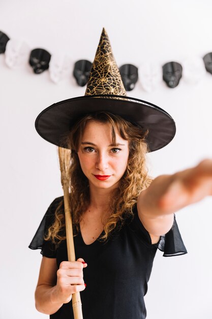 Teenage girl in pointy hat with broom