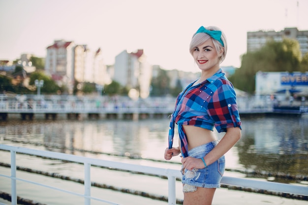 Teenage girl posing in a plaid short t-shirt