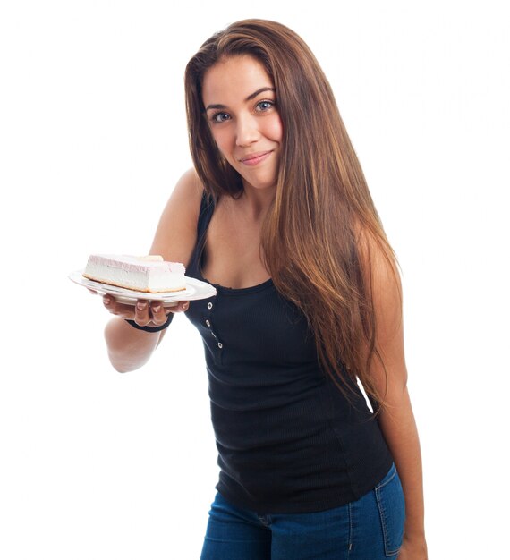 Teenage girl posing with dessert on plate.