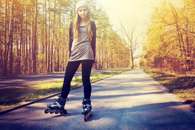 Free photo teenage girl on roller skates at summer.