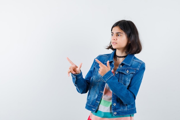 Teenage girl showing the left with her fingers on white background