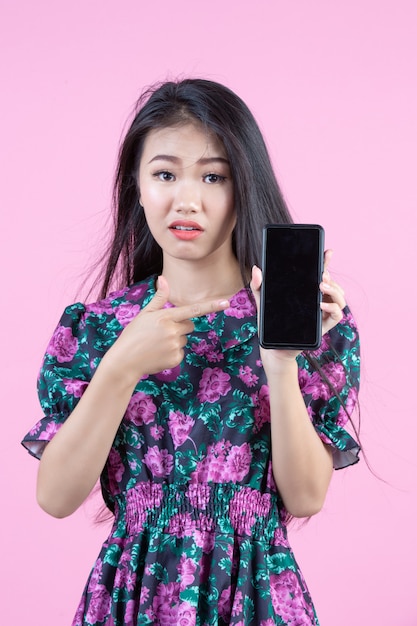 Teenage girl showing phone and facial emotions