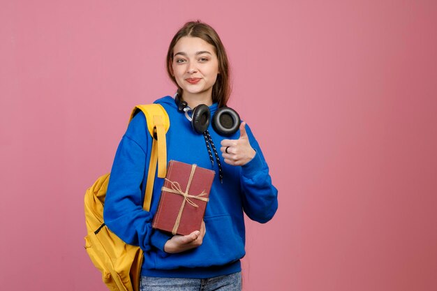 Teenage girl standing holding present gift box