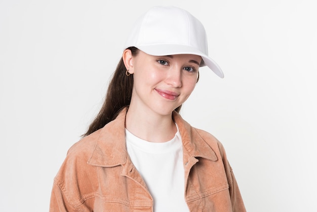 Teenage girl in stylish outfit and white cap studio portrait for youth apparel shoot