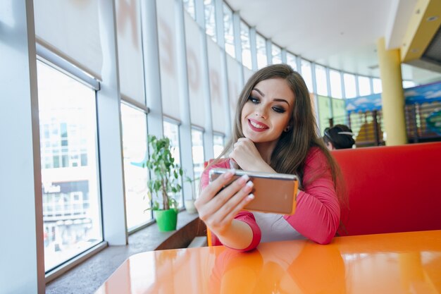 Teenage girl taking an auto photo and smiling