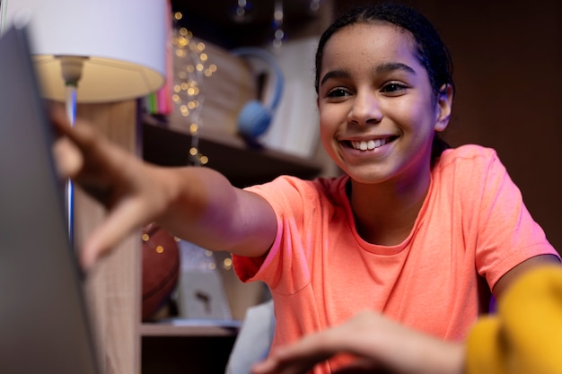 Free photo teenage girl using laptop at home