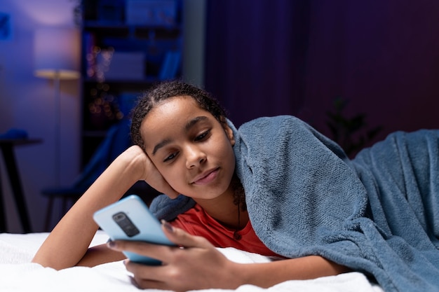 Free photo teenage girl using smartphone at home