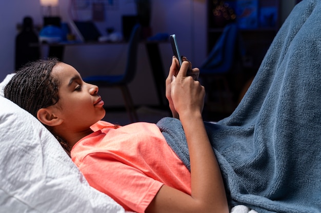 Teenage girl using smartphone at home