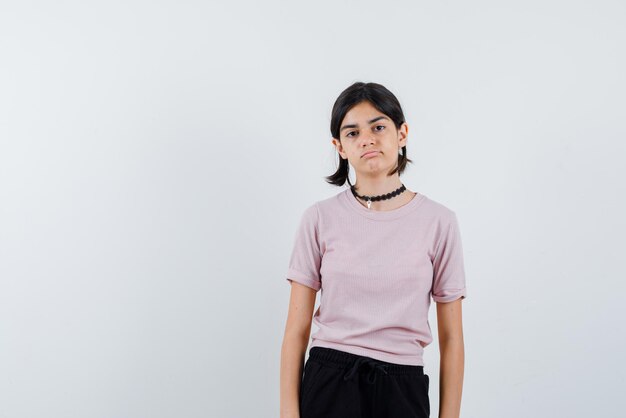 Teenage girl with puckering lips on white background