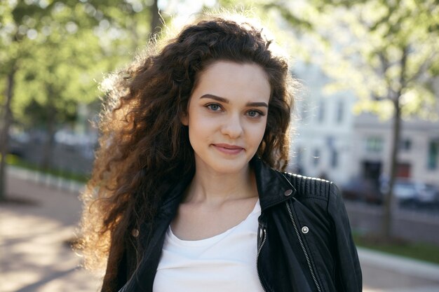 A teenage girl with a wavy hairstyle posing