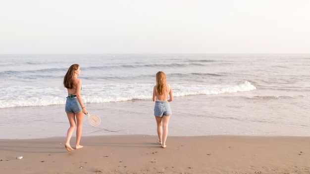 Teenage girls playing at coast near the sea