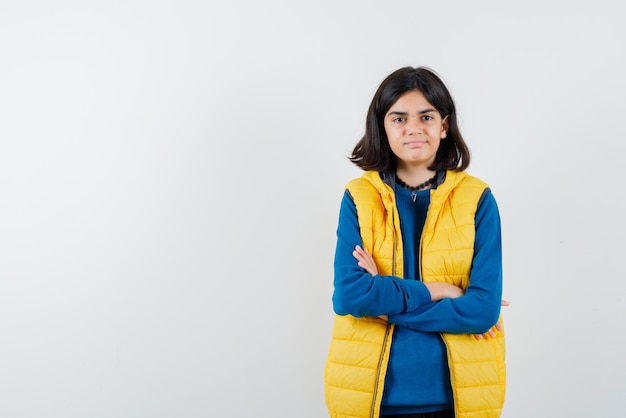 The teenage is thinking by crossing her arms on white background