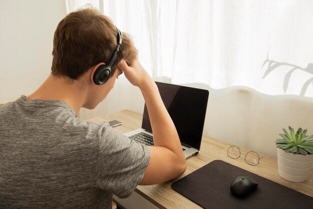 Teenager boy doing online classes