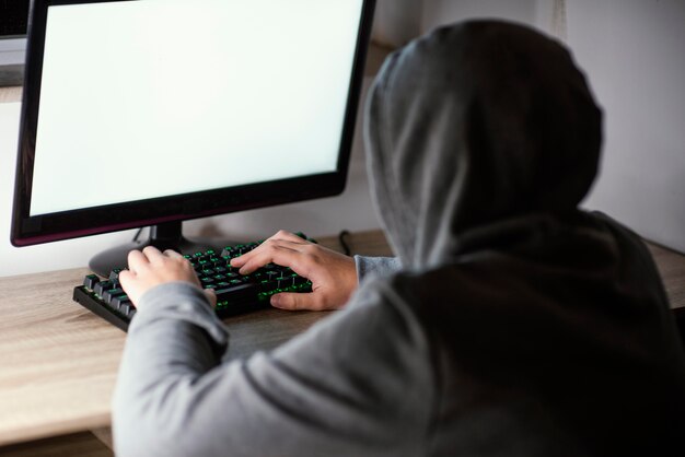 Teenager boy playing on computer