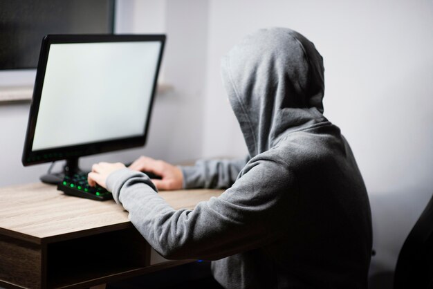 Teenager boy playing on computer