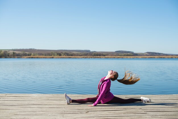 Teenager doing splits and shaking hair