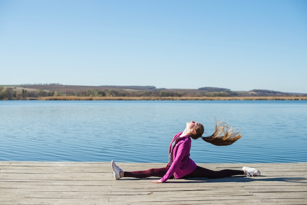 Teenager doing splits and shaking hair