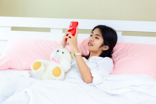 Teenager female use smartphone on the bed