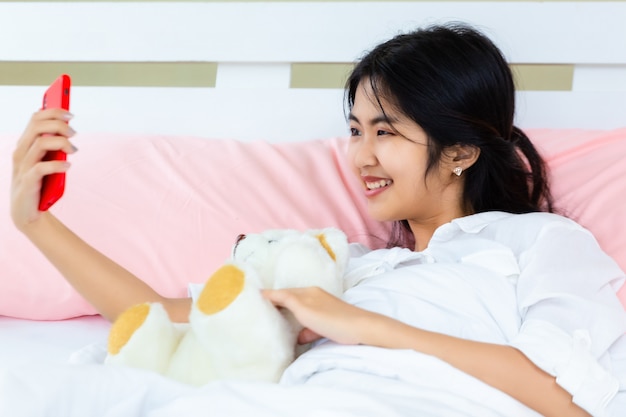 Teenager female use smartphone on the bed