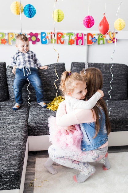 Teenager and girl hugging on party