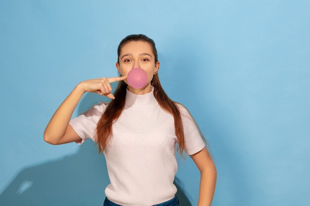 Teenager girl inflating bubble of gum
