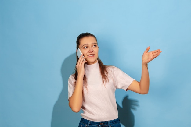 Teenager girl talking on smartphone, smiling