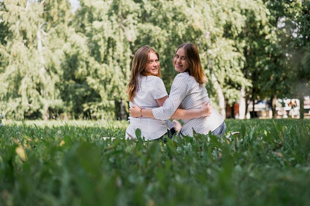 Teenager girls hugging at looking at camera