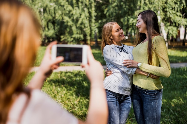 Teenager girls taking photo of each other