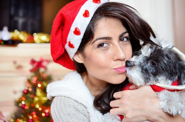 Teenager giving a kiss to her dog