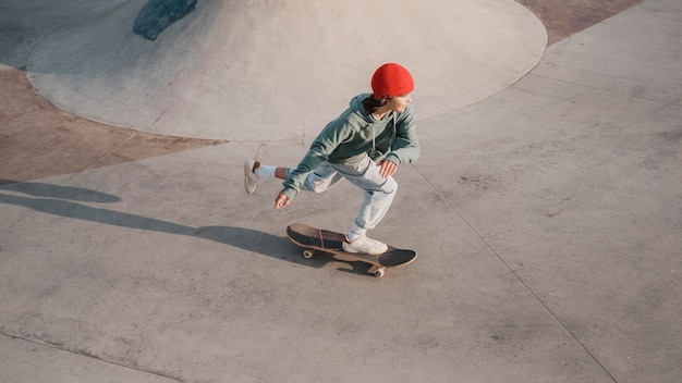 Teenager having fun at the skatepark with skateboard
