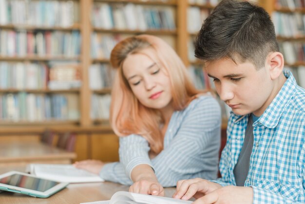 Teenager helping friend with homework
